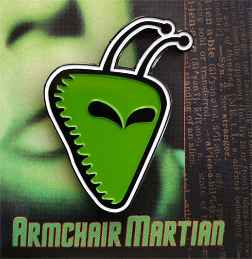 Armchair Martian enamel pin on card back.